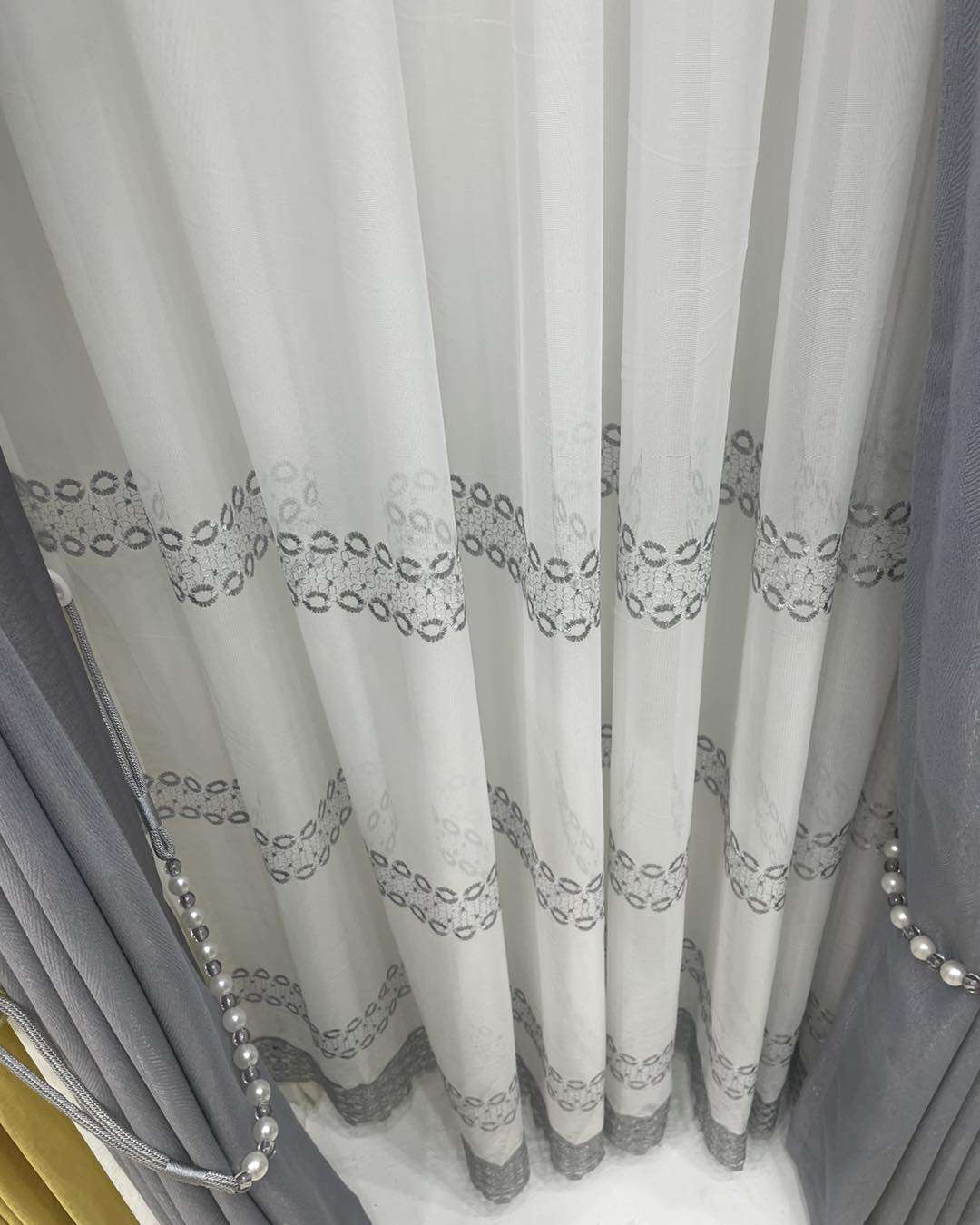 High-quality sheer curtain fabric displayed in soft, flowing layers at Zimark Curtain shop, Nairobi.