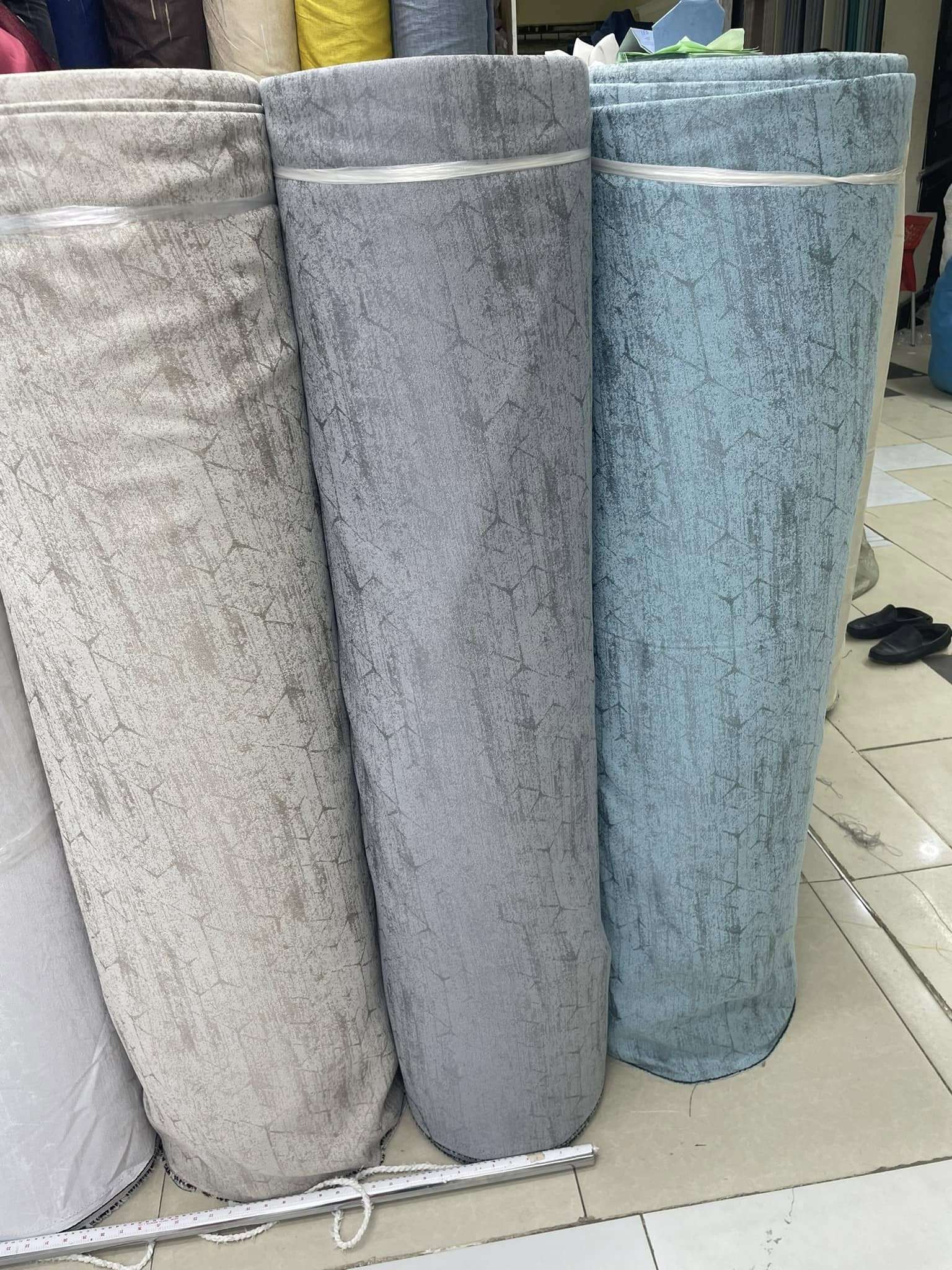 Colorful rolls of premium curtain fabric neatly arranged for sale at Zimark Curtain shop, Nairobi.