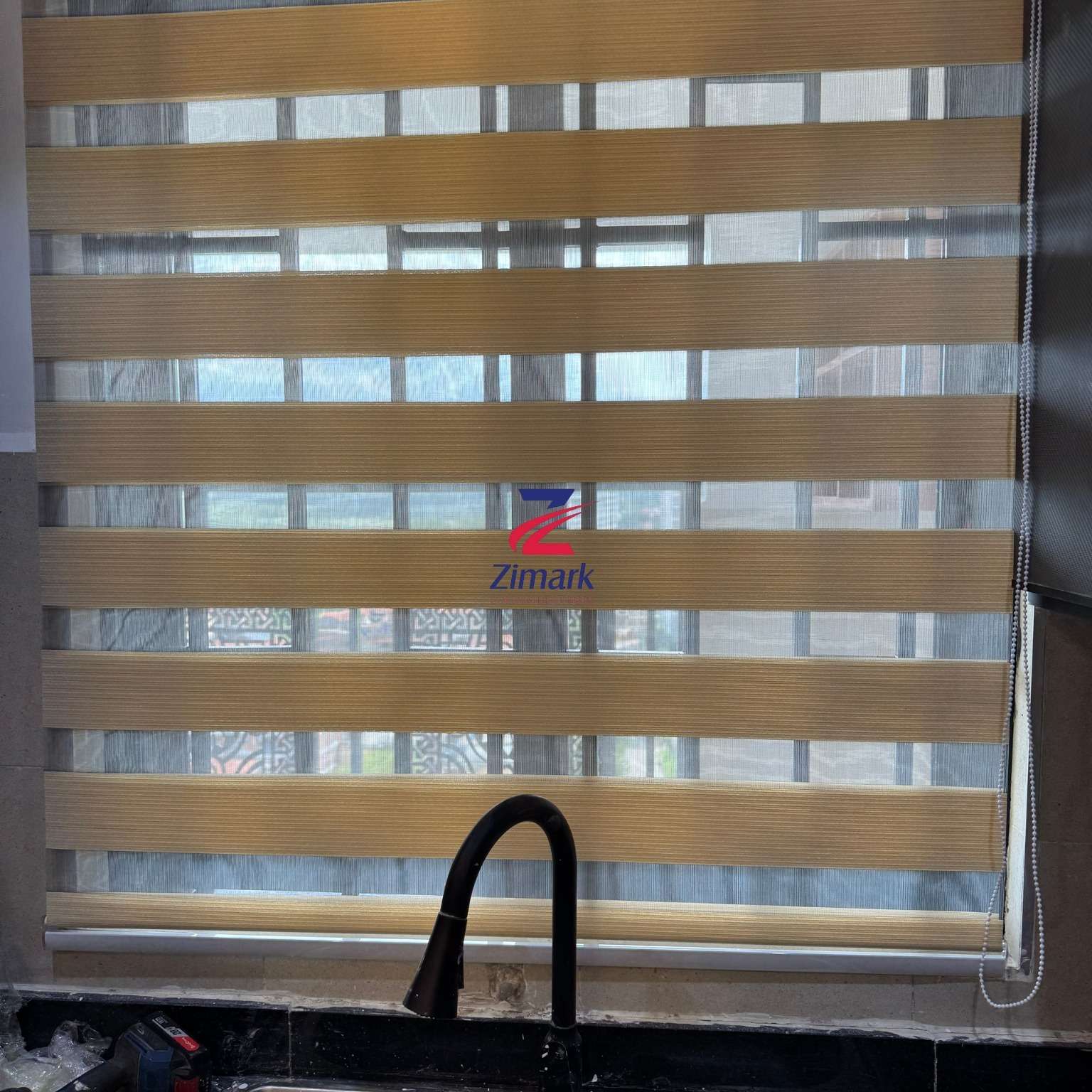 Assorted window blinds including vertical, horizontal, and roll-up styles on display at Zimark Curtain shop.