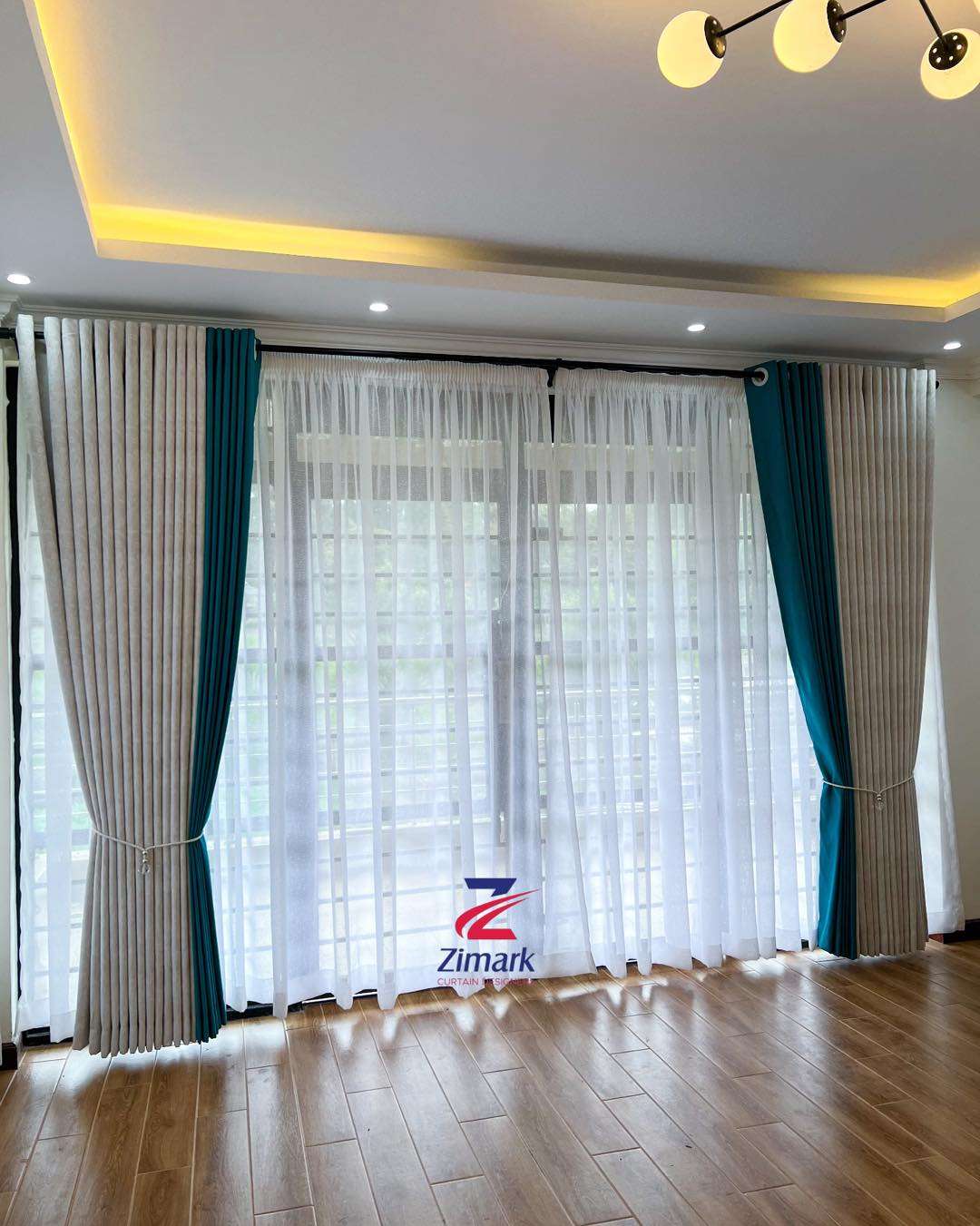 Elegant full curtain set with matching sheers and rods installed in a modern living room

