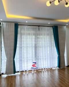 Elegant full curtain set with matching sheers and rods installed in a modern living room