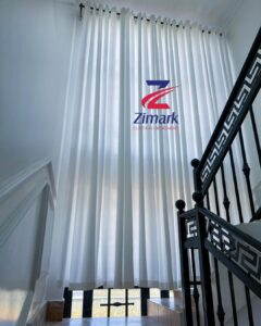 Tall windows with elegant length curtains from Zimark Curtain